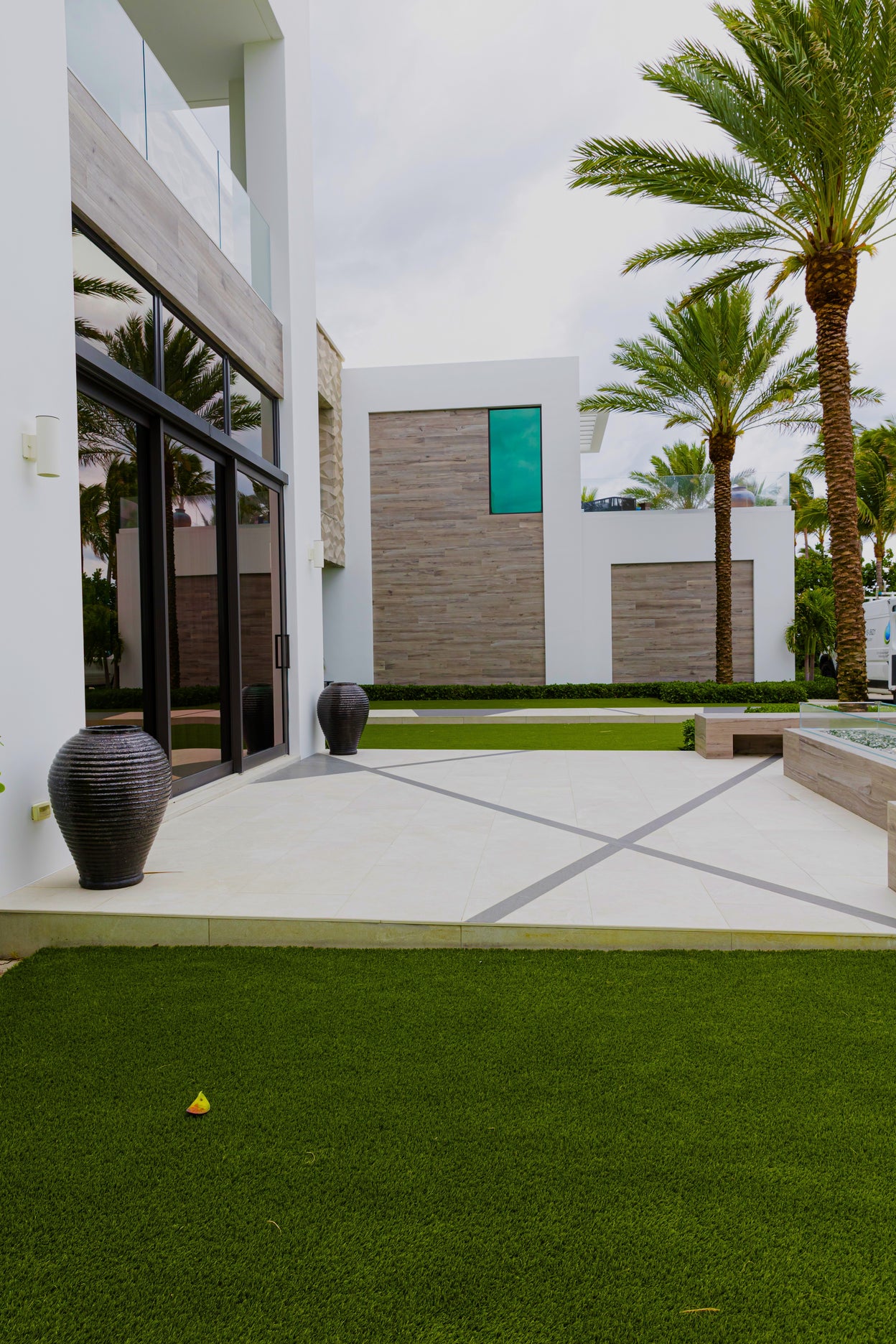 Modern building exterior with palm trees and a clear sky